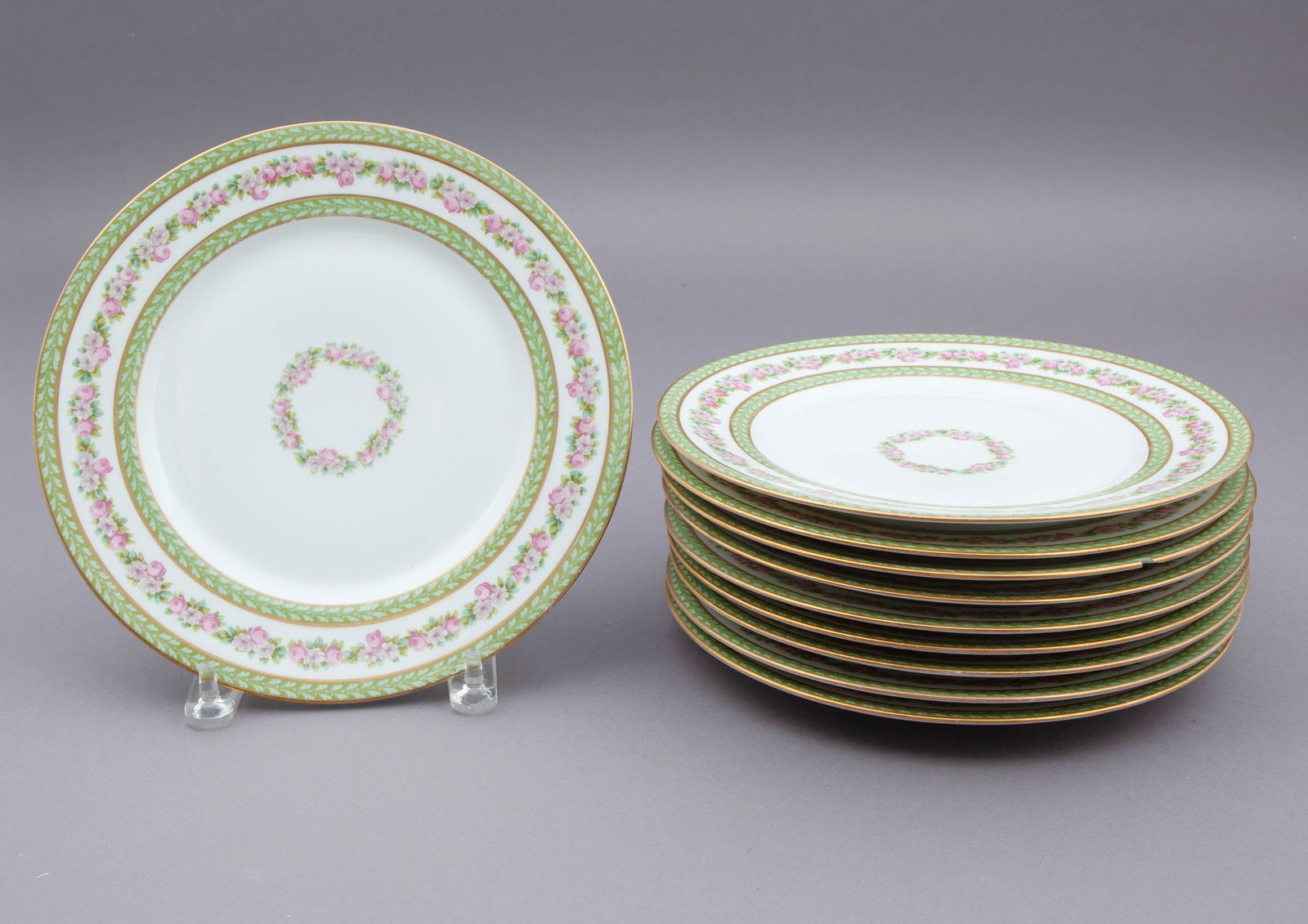Set of 12 Wm Guerin & Co Limoges Dinner Plates: Set of 12 dinner plates measuring 10 inches diameter. Decorated with pink flowers and green leaves on rim. Marked on underside. Some chips.