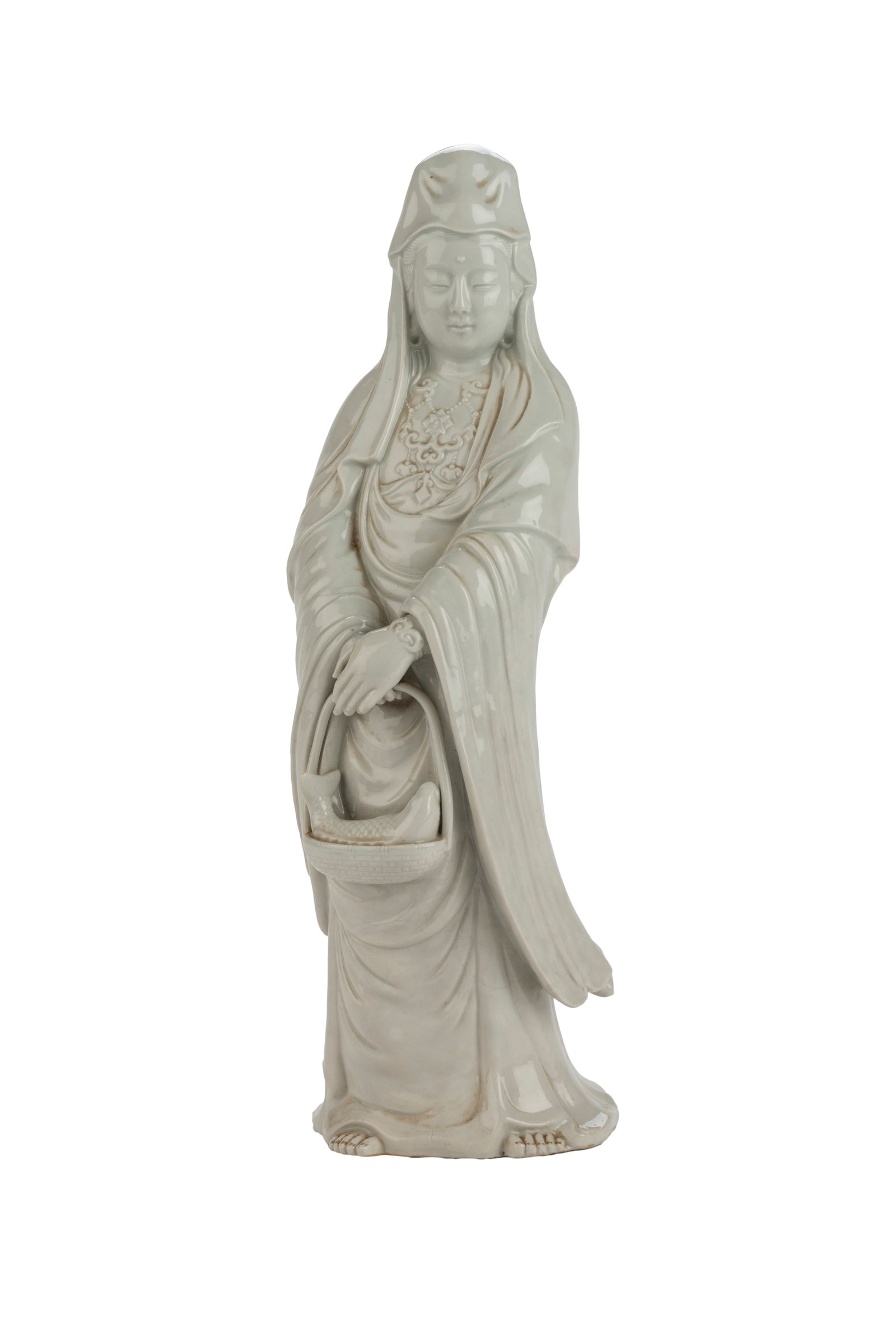 Chinese Qing White Porcelain Guan Yin: She is holding a fish basket in her hands, wearing a babushka and a long robe. Circa 18th - 19th century 17 H x 5 W x 8 D in Good Condition.