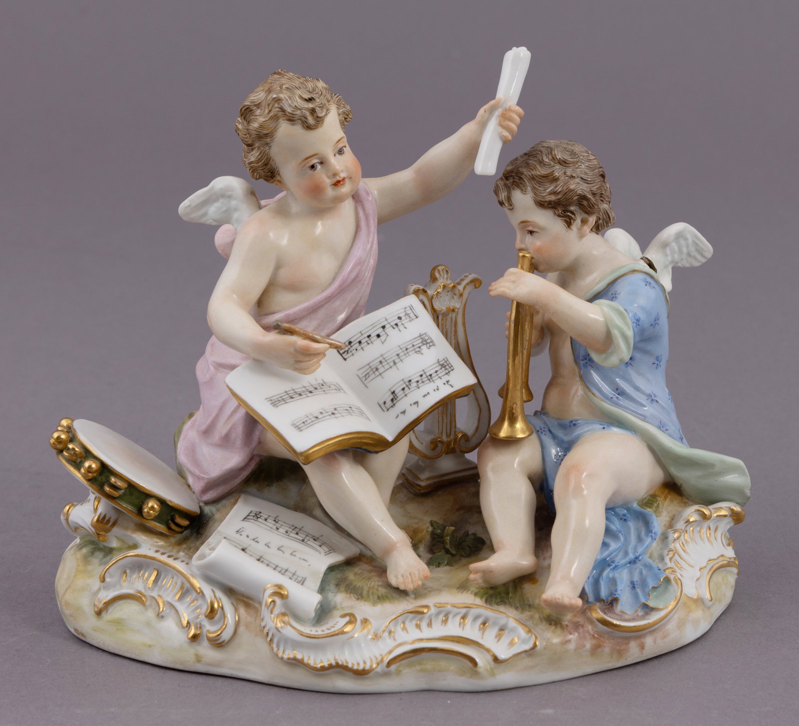 19th Century Meissen Porcelain of Putti Playing Music: Portraying two puttis writing and playing music. Marked on underside. Measuring H 5 W 6 D 4 inches Condition: damage to one of the wings.