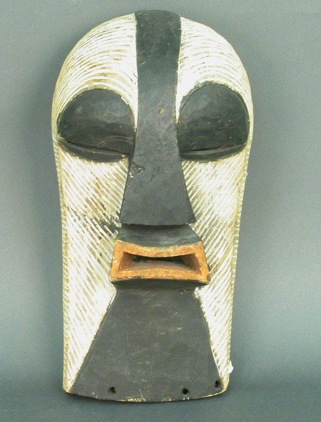 Tribal carved wood mask with grooved fa: Tribal carved wood mask with grooved face and pierced holes around perimeter. Eyes, nose and mouth are painted black, lips are red, upper right side has and area where wood is missing - 14"t x 7"w x 7