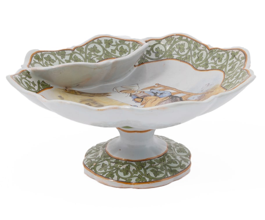 French Faience Dipping Compote by Porquier Beau Quimper: An elegant compote, marked with PB monogram on underside. Decorated with a knitting woman in traditional Breton attire, featuring a green ivy arabesque on the rim. Measuring H 4.5 W 9.25 i