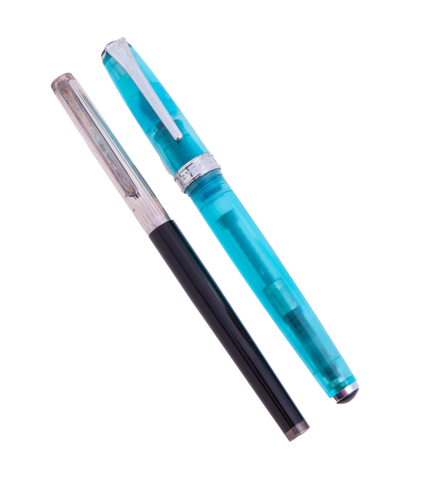 Pair of Levenger Vintage Fountain Pens: Including: - Silver-capped Levenger fountain pen with 18k yellow and silver nib and black body. - Blue translucent fountain pen with silver-tone nib. In fair condition, with no box or pape