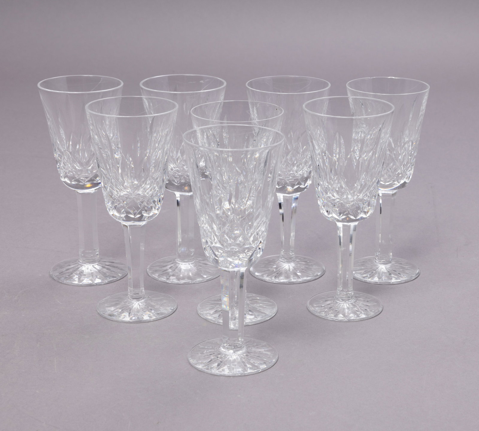 Eight Waterford Lismore Crystal Sherry Cordial Glasses: Eight stunning Waterford crystal sherry cordial glasses. These glasses are in the iconic Lismore design with a faceted stem and base. All glasses have the Waterford maker's mark on the underside of th