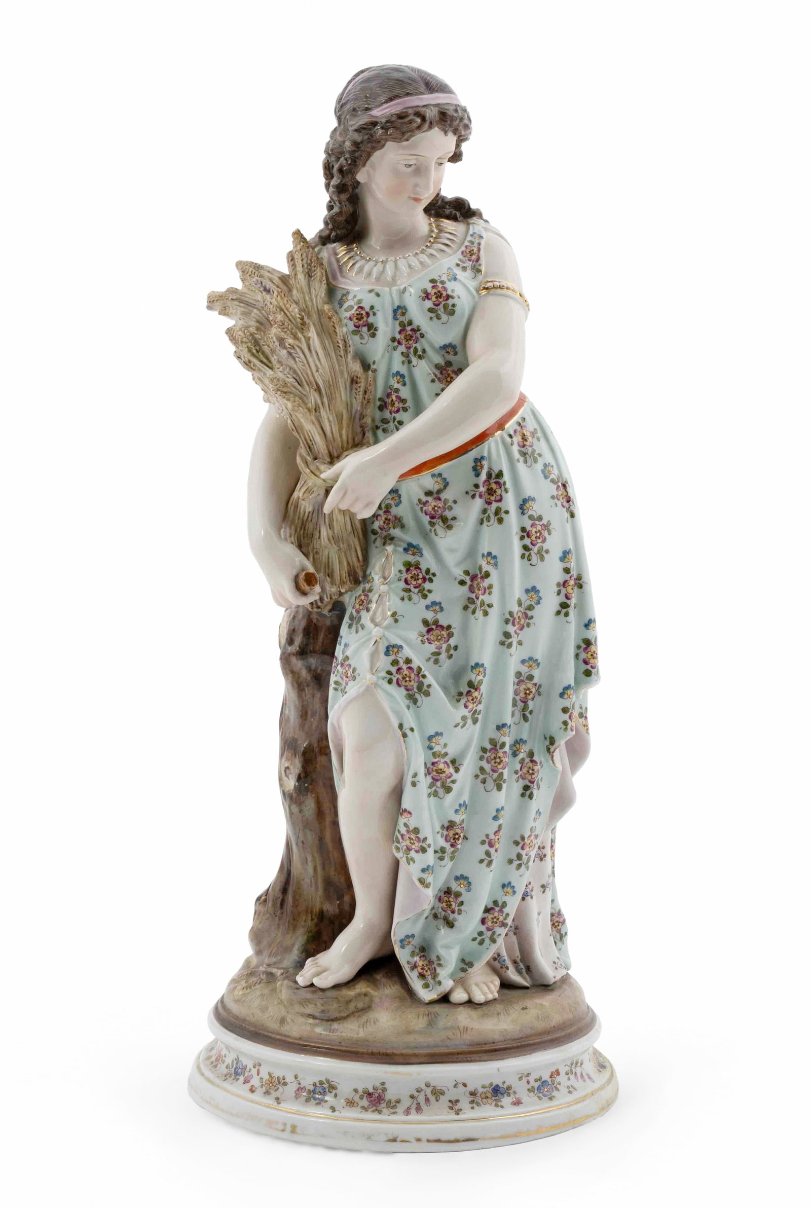 Late 19th Century German Porcelain Female Figure: A beautiful German porcelain figure of a woman during harvest. She is dressed in a beautifully decorated aqua dress and is carrying wheat. It is marked on the underside of the piece with a blue porcel