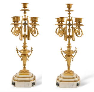 Vintage Pair of French Marble Based Brass Candelabras: Beautiful set of two brass candle stick holders with a marble base. These feature a French-style motif with ornate carvings of the metal where the candlesticks are held. Able to hold five candles per