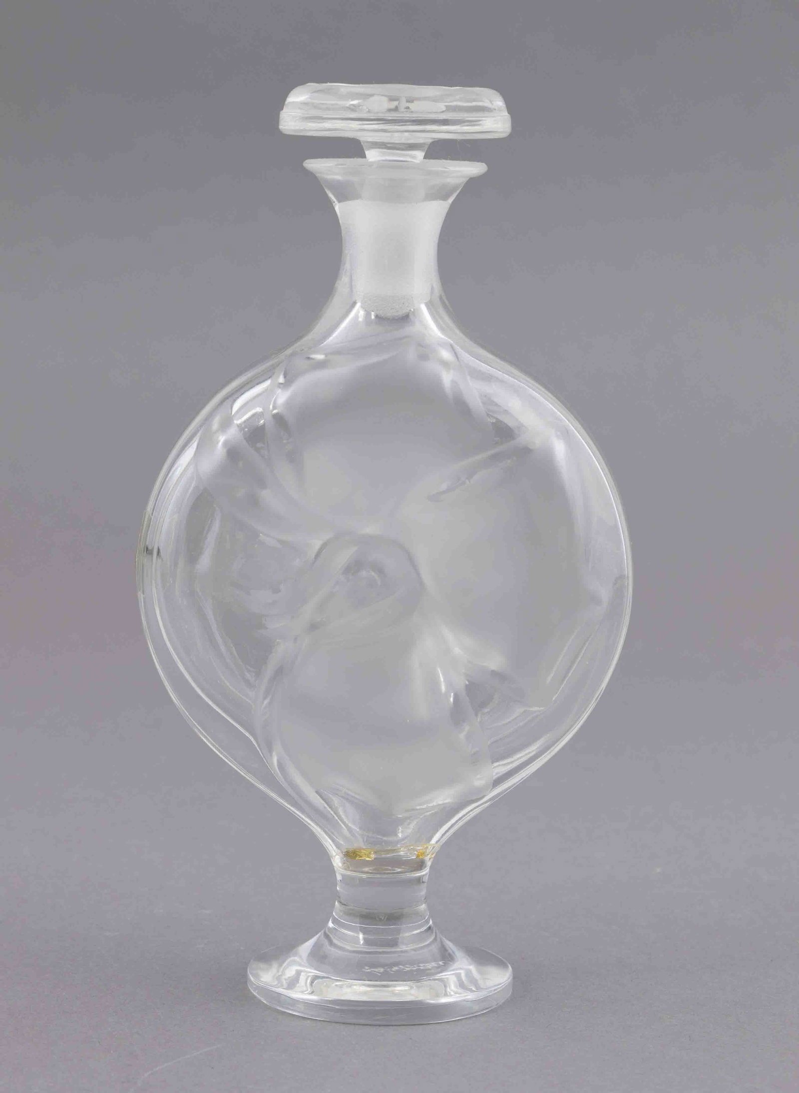 Lalique Moulin Rouge Perfume Bottle: A beautiful Lalique Moulin Rouge perfume bottle. It is marked with the Lalique maker's mark on the underside of the base. It measures H 7 W 3.5 D 1.75 inches. Condition: Very good 