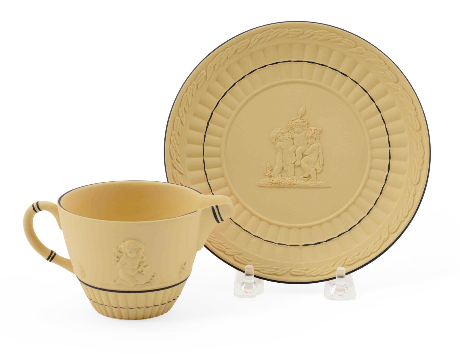 Wedgwood Jasperware Pouring Cup and Saucer, Black on Yellow: Two beautiful Wedgwood pieces in yellow with black trim jasperware pouring cup & saucer with a cane pattern and cherub figures. Both pieces are marked on the bottom with the Wedgwood engraving. Th