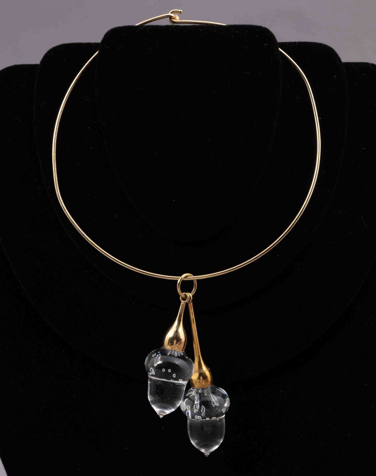 Steuben Glass Acorn Necklace in Gold: A gorgeous Steuben glass acorn necklace in gold. The acorns are marked with the Steuben "s" and the necklace indicates 18K on the piece. It measures 5 inches in diameter, while the acorns me