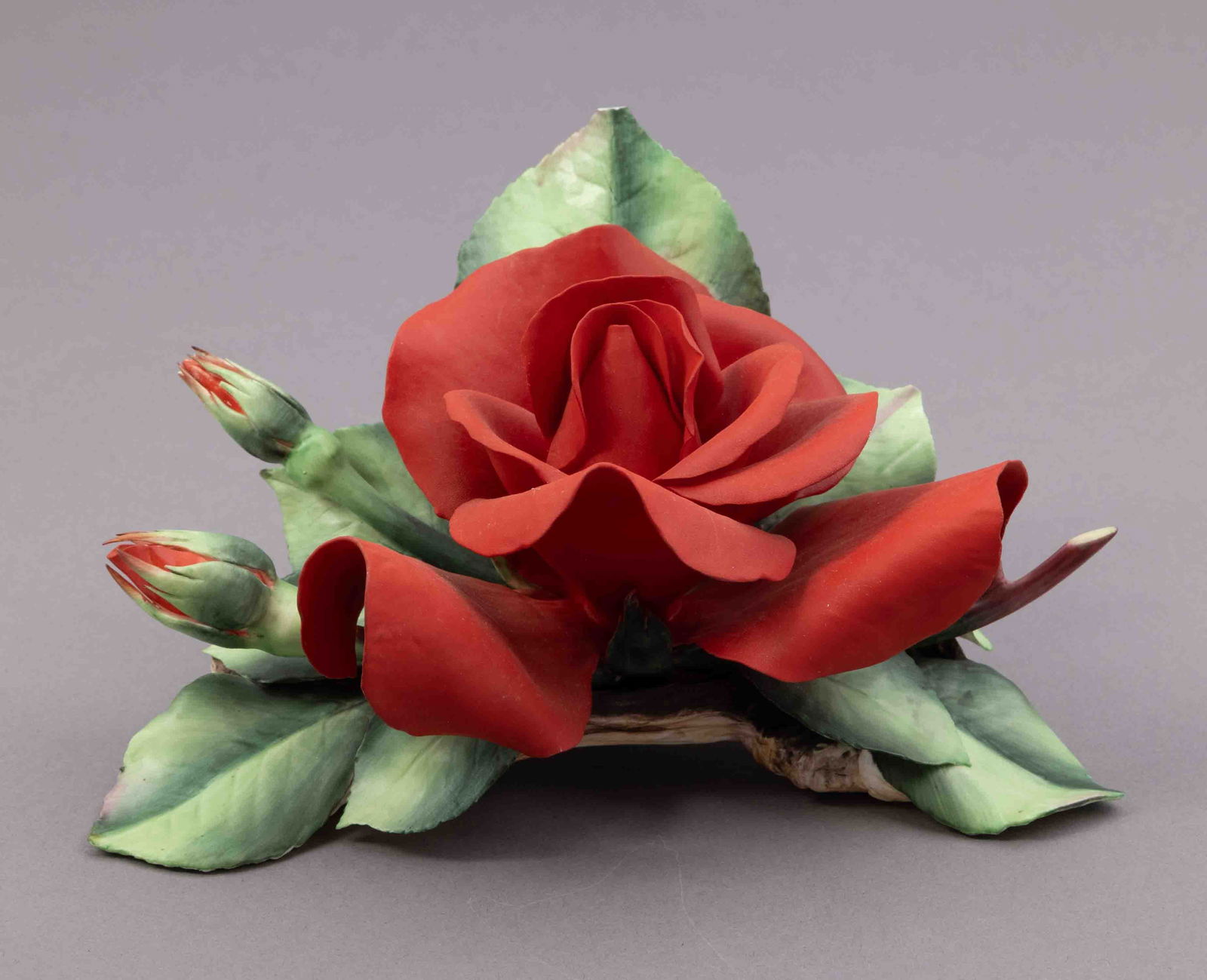 Boehm Bone Porcelain Flower, The Nancy Reagan Rose: Boehm bone porcelain floral figurine of a red rose. Marked on underside. Measuring H 4 W 7 inches Condition: slight damage to the top leaf