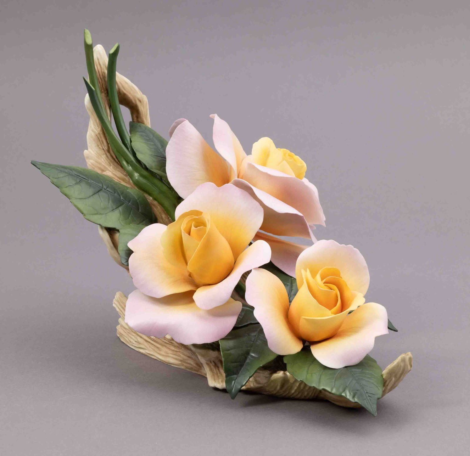 Boehm Bone Porcelain Flower, Bonsoir Roses: Boehm bone porcelain floral figurine of a pink and yellow roses. Marked on underside and signed. Measuring H 8 W 9 inches Condition: missing petal.