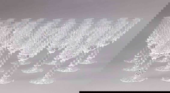 Set of Twelve Waterford Crystal Water Goblets: Set of twelve Waterford crystal water goblets with faceted stems and bases. They are all marked on the underside with the Waterford maker's mark. They measure H 7 W 3.5 D 3.5 inches. Condition:
