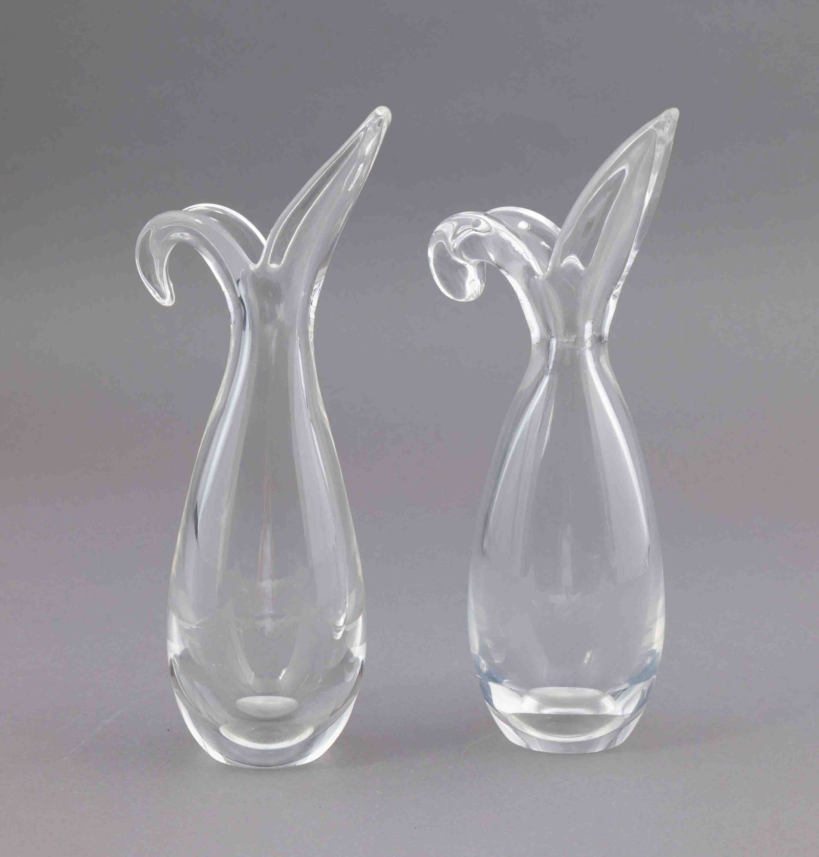 Pair of Steuben Sheared Rim Vases: A pair of beautiful sheared rim Steuben glass vases. They are both marked on the underside with the Steuben maker's mark. They measure H 10 W 5.5 D 3.5 inches. Condition: minor scratching to the