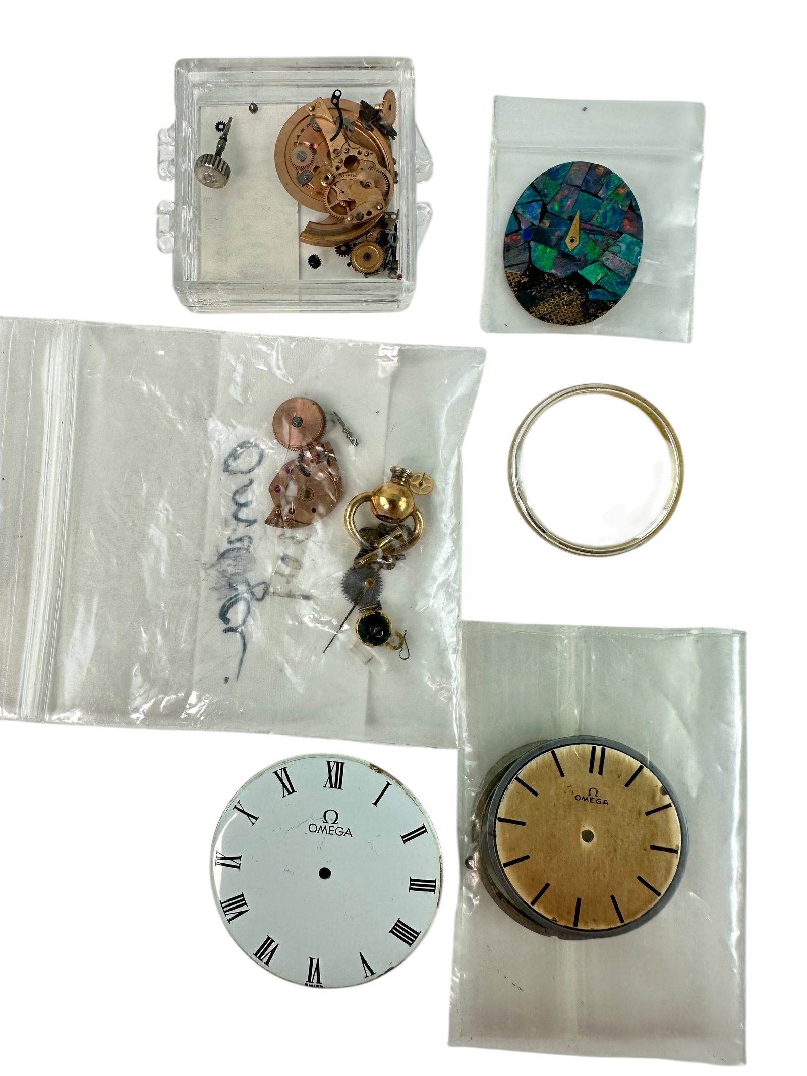 Collection of Vintage Omega Parts and Dials: Included in this lot. Crystal Movements, pins, crowns, dials including an opal ladies dial ETA901001 movement