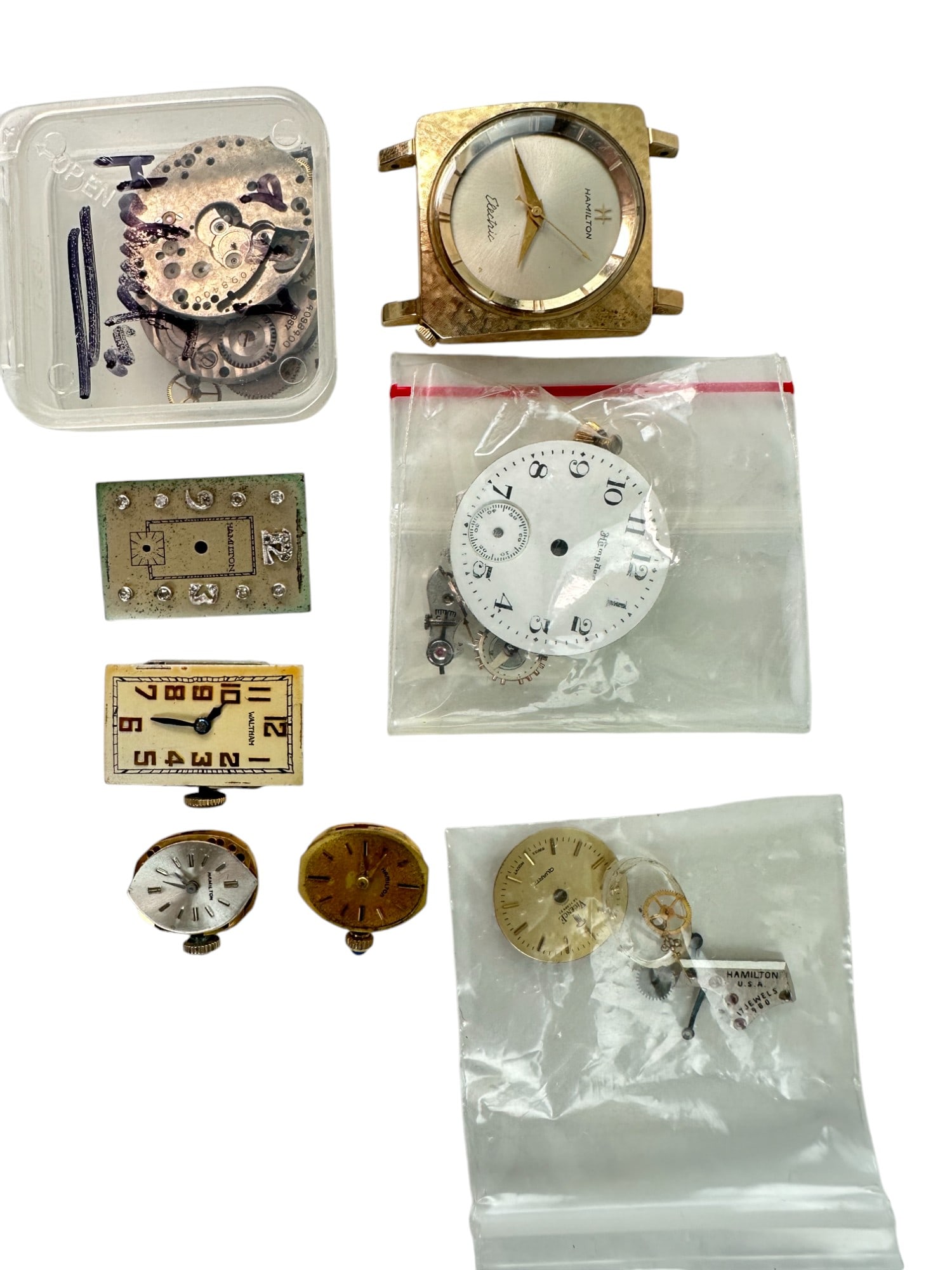 Collection of Vintage Hamilton Movements & Dials: Including Gold dial, wheel - Ladies Two vintage ladies oval dials and movements Mens Rectangular 1920s Dial and Movement Mens dial with diamond markers Box of Hamilton 987 parts Hamilton Electric dia