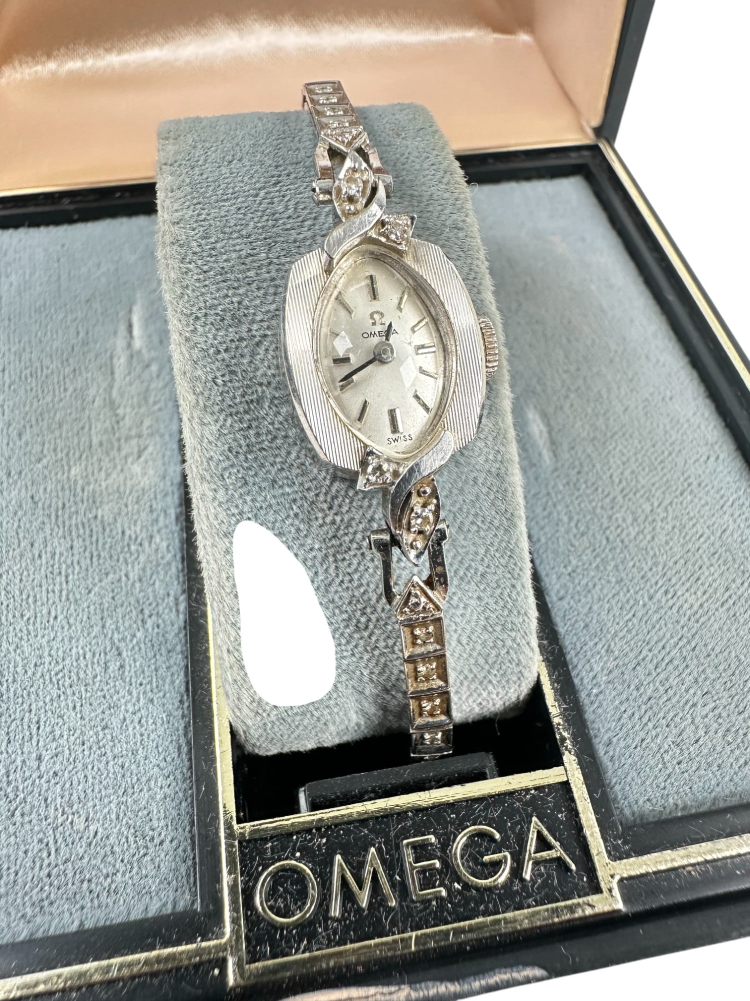 Vintage Ladies Omega Gold Watch with Original Box: A wonderful vintage ladies Omega wristwatch in 14kt white gold with diamonds. Mechanical wind with factory box. Circa 1950s.