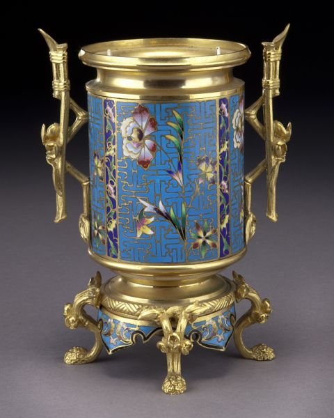 French aesthetic champleve and gilt bronze urn: French aesthetic champleve and gilt bronze urn with liner, raised on four floriform feet, naturalistic reed-form handle to each side. Unmarked. 7.75"H, Circa - 19th C.