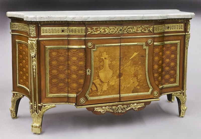 Louis XVI style ormolu mounted marble top commode: Louis XVI style ormolu mounted marble top commode after the model by Jean-Henri Riesener, with elaborate marquetry and parquetry inlays to front and sides and heavy ormolu mounts. This piece has been