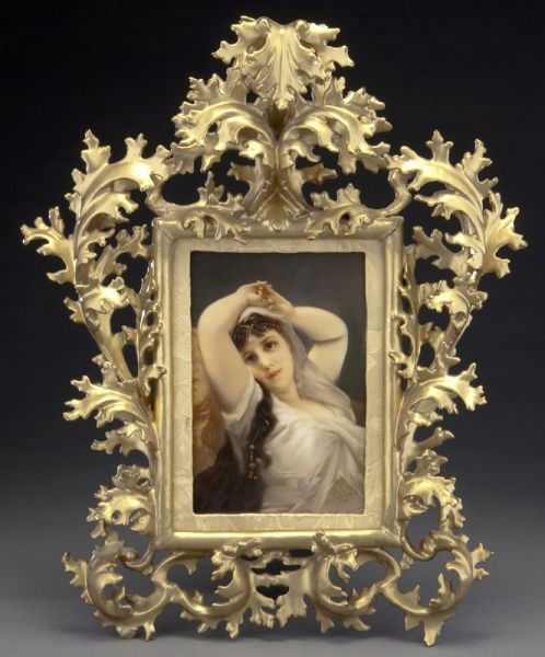 KPM Berlin painted porcelain plaque: KPM Berlin painted porcelain plaque depicting a draped lady reclining against a rock, in an ornately carved Florentine style frame. Verso impressed "KPM", with scepter and other various marks. Profess