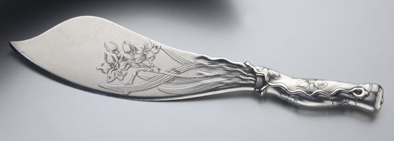 Whiting sterling silver cake knife,: Whiting sterling silver cake knife, the blade and handle with applied decoration and etched with flowers and vines. Stamped for Whiting, "Sterling" and retailer "Theodore B. Starr," 5.165 ozt. 10''L, 