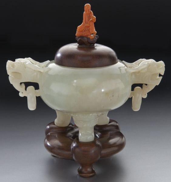 Chinese Qing carved jade tripod censer: Chinese Qing carved jade tripod censer with two dragon head handles with free rings and a coral finial, raised on a carved rosewood stand. (This item cannot be shipped internationally). Jade: 4"H x 4.