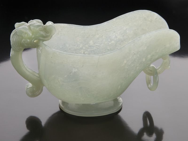 Chinese carved jade libation cup: Chinese carved jade libation cup with a free ring and dragon's head handle. 2.75"H x 5"W, Circa - 20th C.