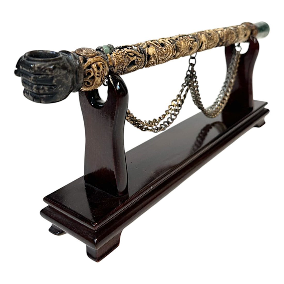 Heavily Carved Antique Chinese Tobacco Pipe: A finely carved Chinese tobacco pipe with molted jade mouthpiece and the bowl is molted serpentine in the shape of a fist. The stem is composed of heavily carved bone over a bamboo core and features t