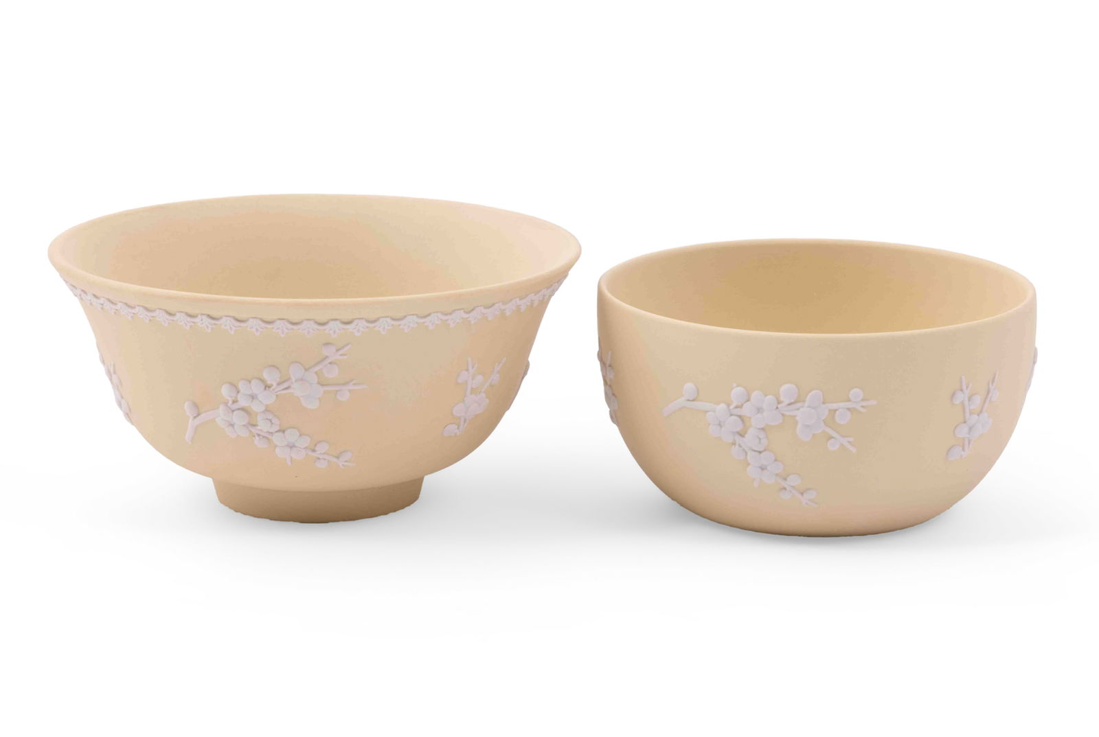 Pair of Wedgwood Jasperware Bowls in Primrose Yellow: Two Wedgwood Jasperware Bowls in Primrose Yellow, featuring a prunus design. Both are marked Wedgwood Made in England on underside. Measuring: H 3 x W 6 x D 6 inches and H 2.5 x W 5 x D 5 inches