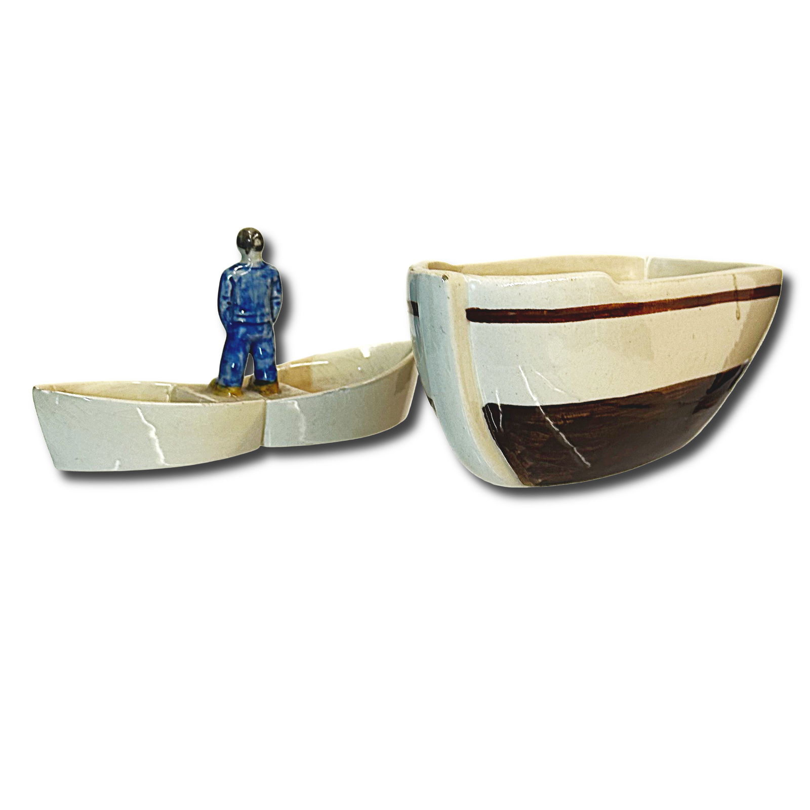 Unique Quimper Ceramic Spice Container: A unique Quimper spiece container in the shape of a boat and a man in blue. Both pieces are marked with a Quimper maker's mark. Dimensions of the boat: H 3 x W 6.5 x D 3 inches Dimensions of man