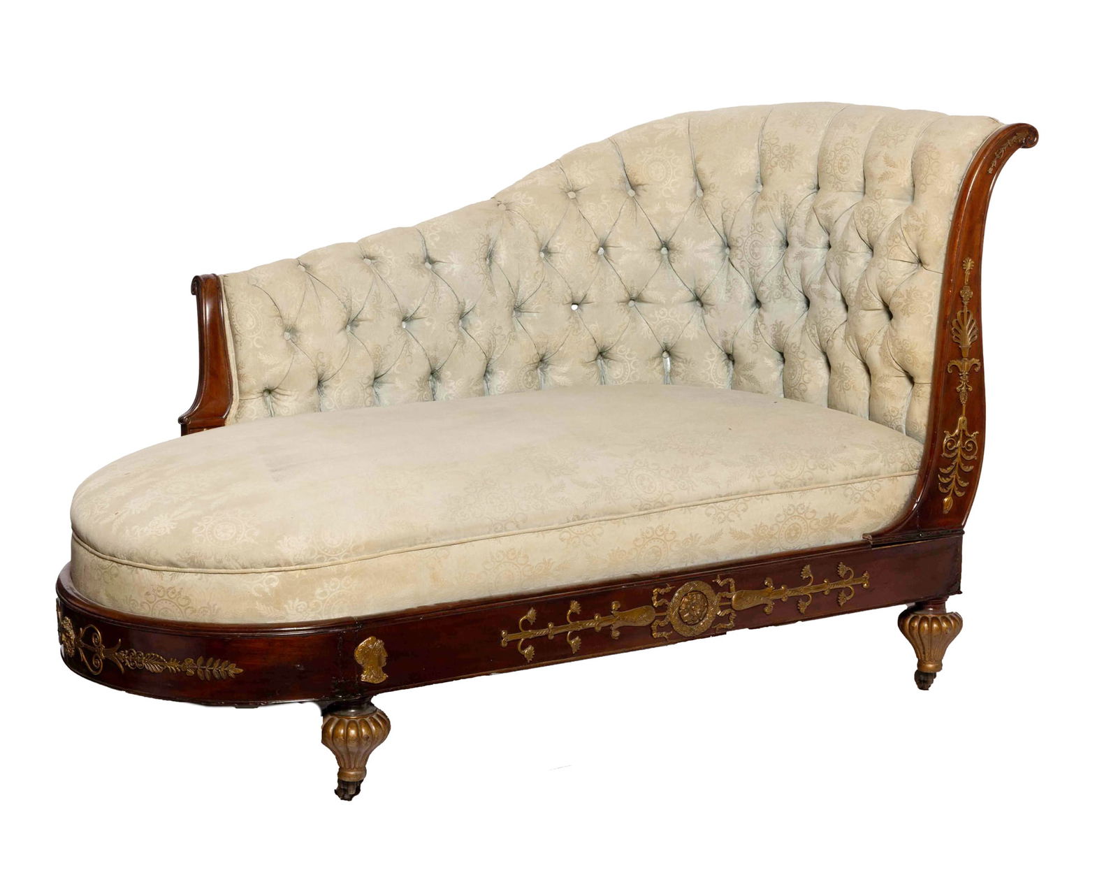 Victorian Carved Wood Chaise Lounge: A carved wooden Victorian chaise lounge upholstered with a grey/cream colored fabric with subtle Victorian motif decor. The piece is accented with metal cast accent pieces attached to the wood. The lo