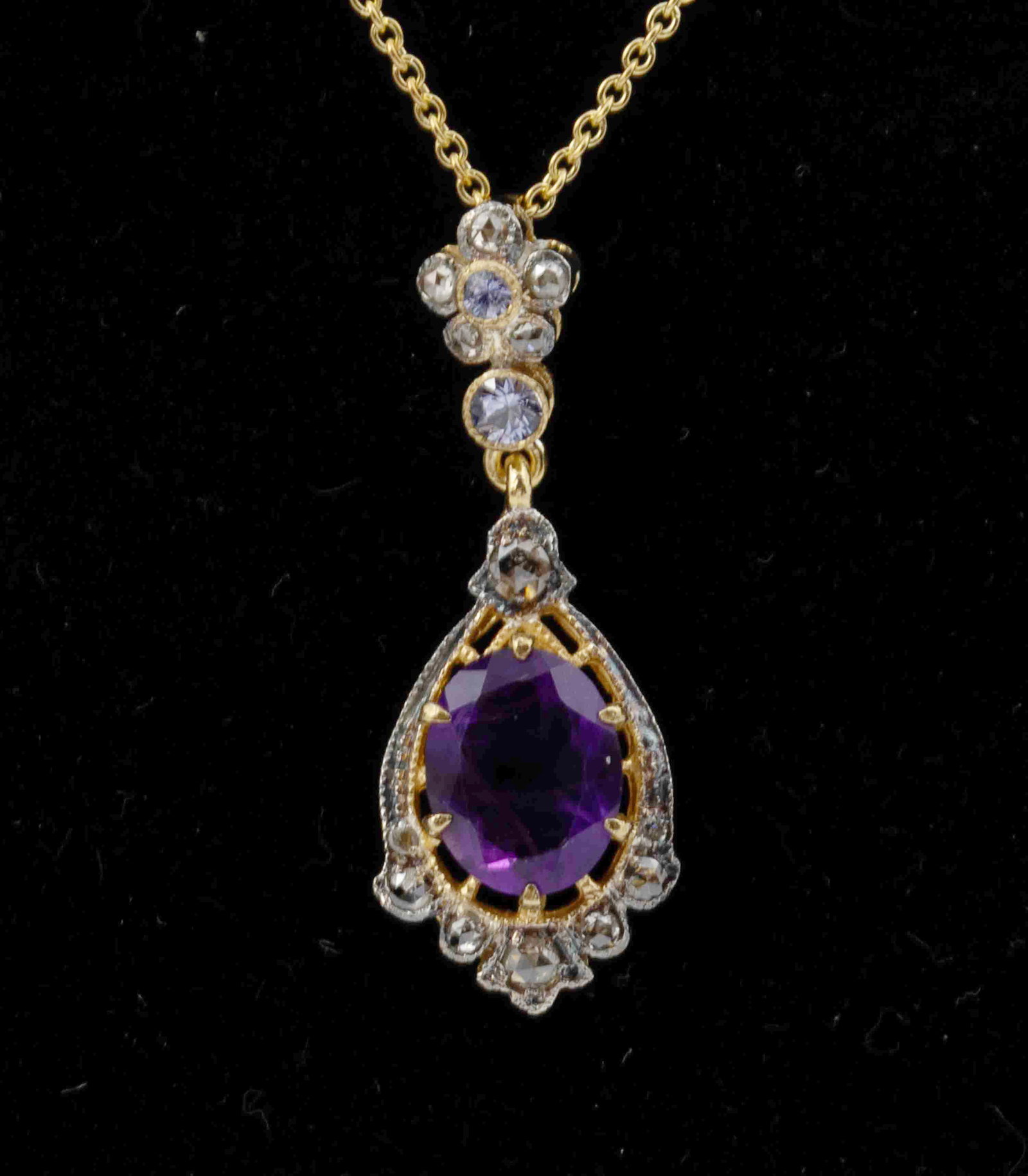 Ladies Necklace Featuring a Large Amethyst Centerstone: This is a beautiful gold & silver necklace with approx 0.1 grams of 14k gold complete with a 1.55-carat amethyst centerstone. It is decorated with 0.15 carats of tanzanite and 13 pieces of rose-cu