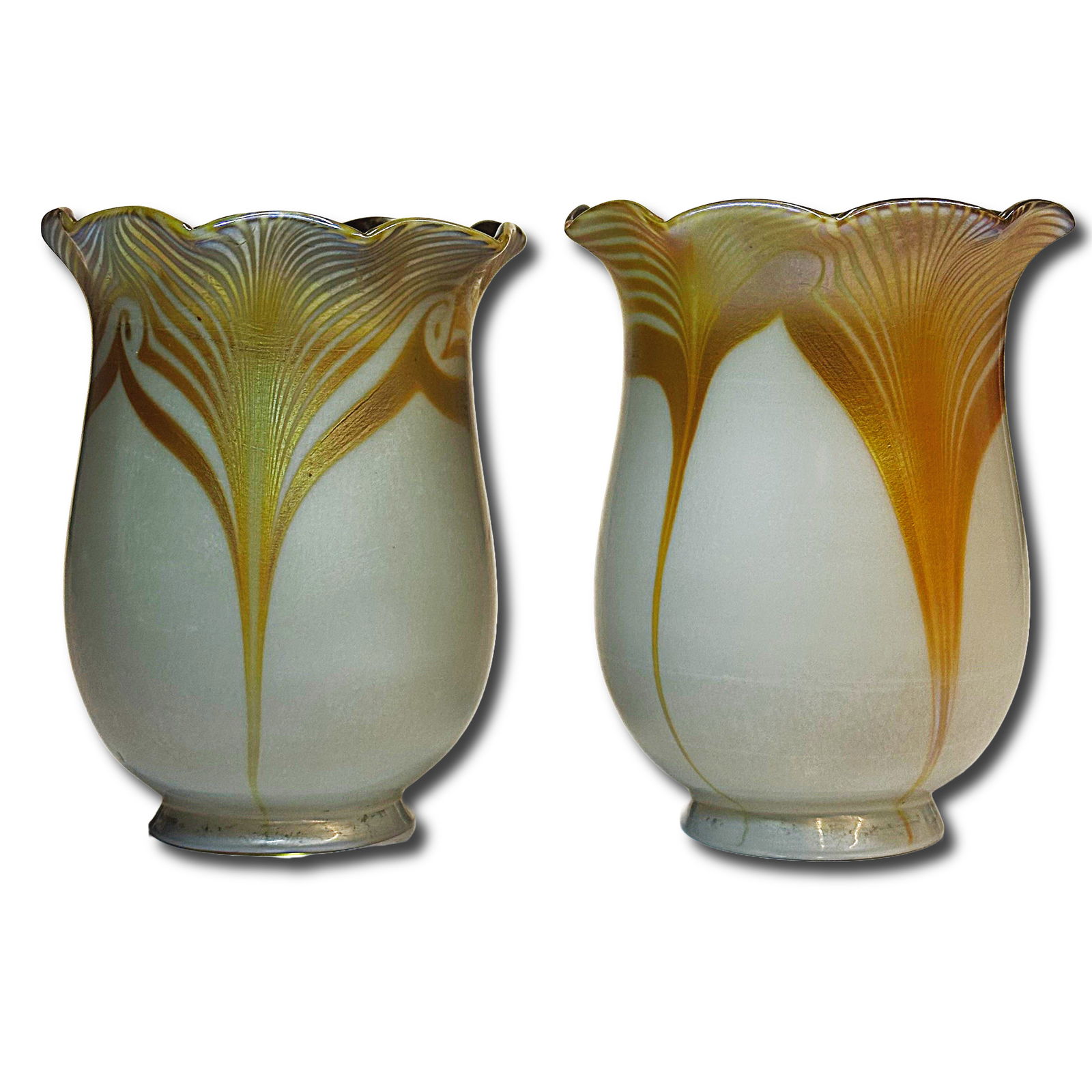 Pair of Decorated American Art Nouveau Art Glass Shades: Calcite exteriors with gold iridescent interiors and gold pulled feathering on the exterior. 2 1/4 inch fitter rims. Dimensions: H 5.5 x W 4 x D 4 inches Unsigned. Art Nouveau era. Condition: ch