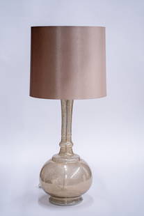 Italian Art Glass Lamp with Linen Shade: A large hand-blown glass lamp in a vase shape. It is translucent, and you are able to see the electric cord running through the base. The shade is composed of linen in a tan or beige coloring.&nbsp; D
