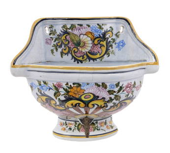 French Faience Wall Mounted Lavabo by Quimper: A stunning wall-mounted lavabo, marked AA Qimper on underside. In light blue, finely decorated with summer flowers and yellow rims, featuring a brass tap. Measuring H 11 x W 11 x D 5 inche