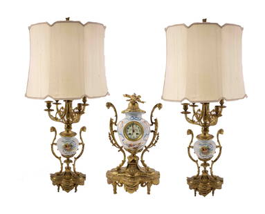 19th Century Continental Porcelain Mantle Clock and Lamps: A beautiful collection of 19th-century porcelain lamps and the matching mantle clock. These continental pieces are adorned with hand-painted figural, musical, and landscape scenes. They are maintained