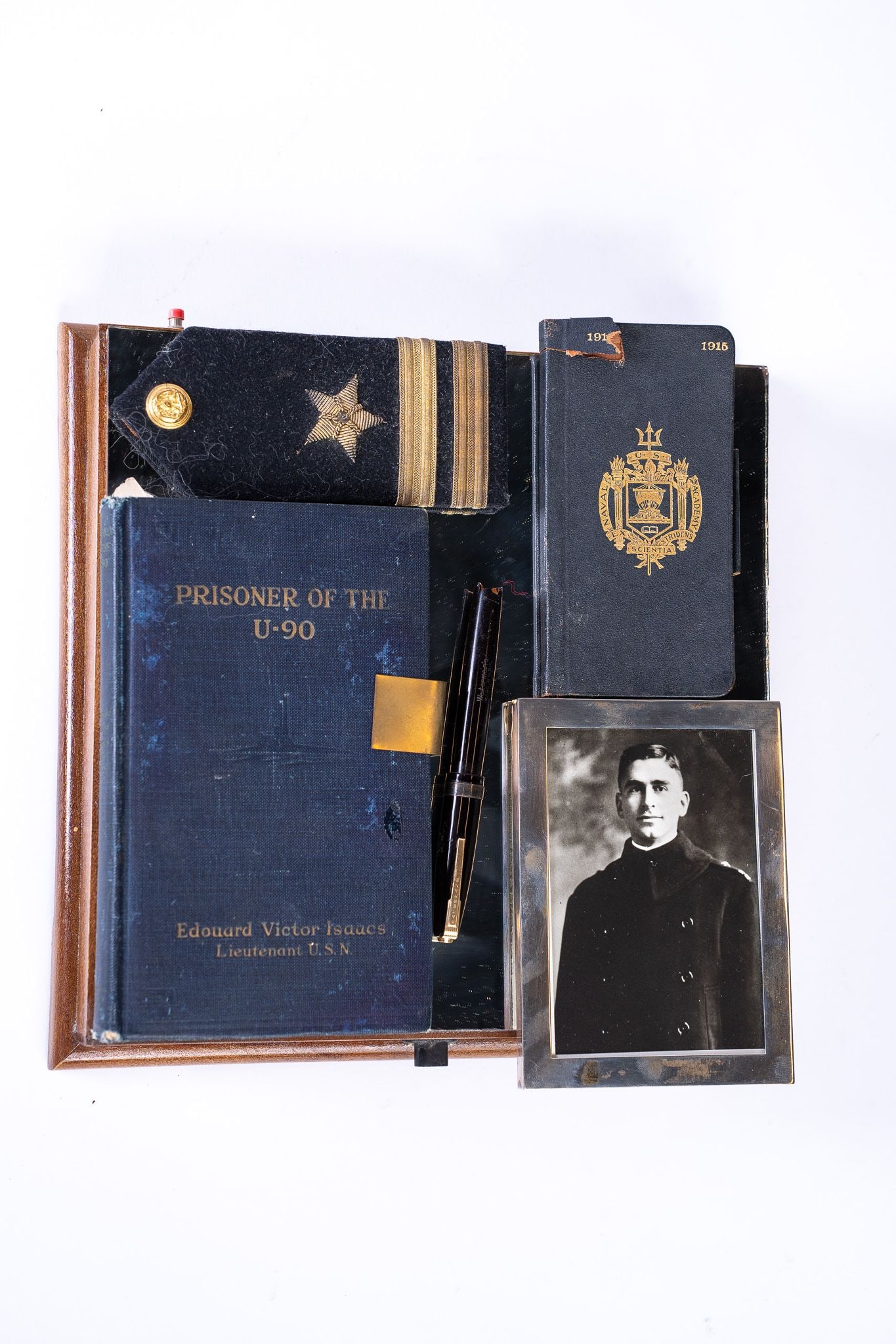 Collection of Early 20th Century US Navy Items Attributed to Edouard Isaacs: Collection of Early 20th Century US Navy Items Attributed to Edouard Isaacs. 1 Naval Academy Book Filled out by Isaacs, 1 Photograph of Isaacs, 1 Book written by Isaacs titled Prisoner of the U-90 Own
