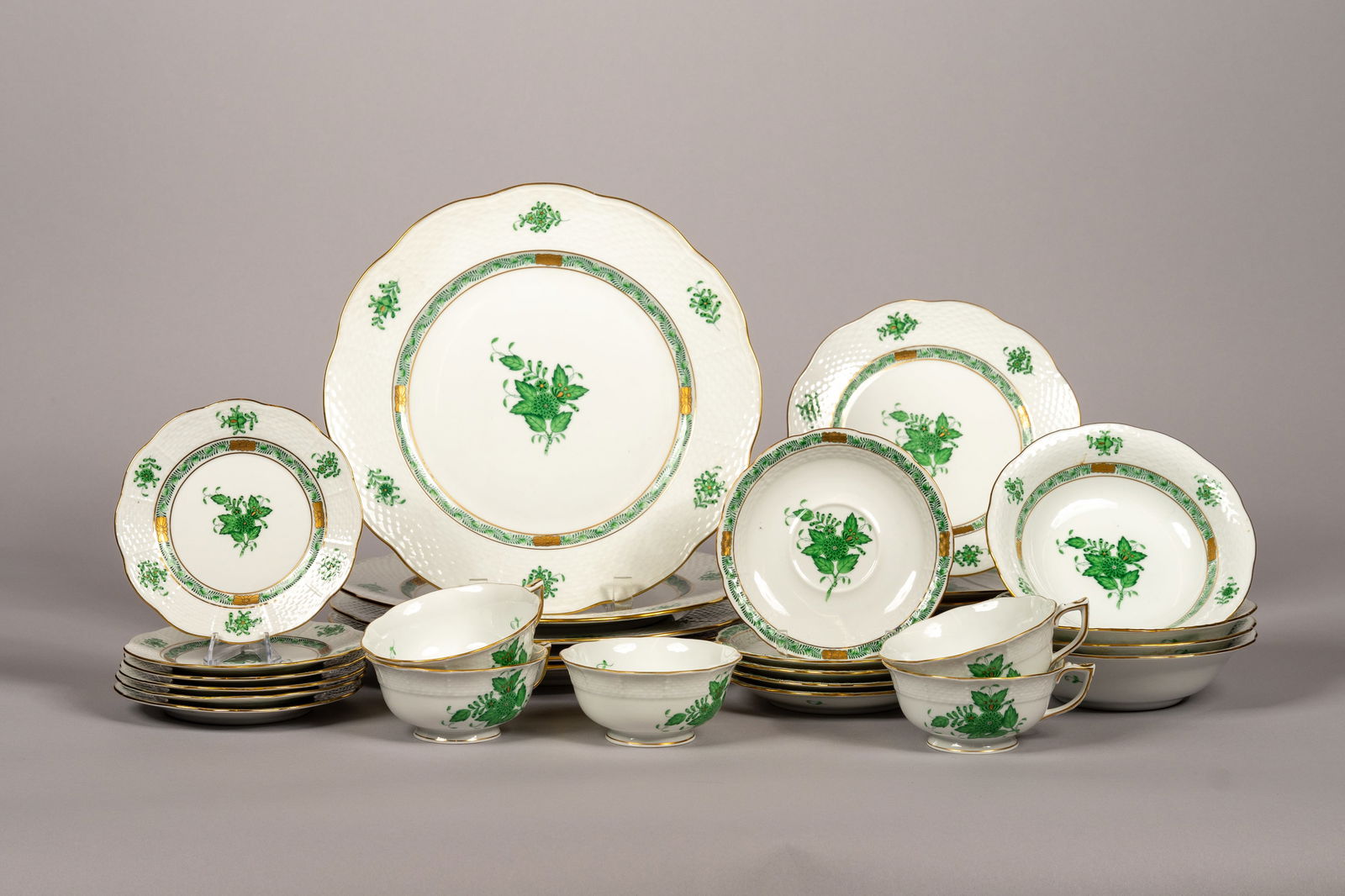 31 Piece Hungarian Herend Green Chinese Bouquet Dinnerware Set: 31 Varying Piece Hungarian Herend Green Chinese Bouquet Dinnerware Set. The set has 5 teacups with accompanying saucers, 4 soup bowls, 6 salad plates, 5 pasta plates, and 6 coasters. This pattern is a