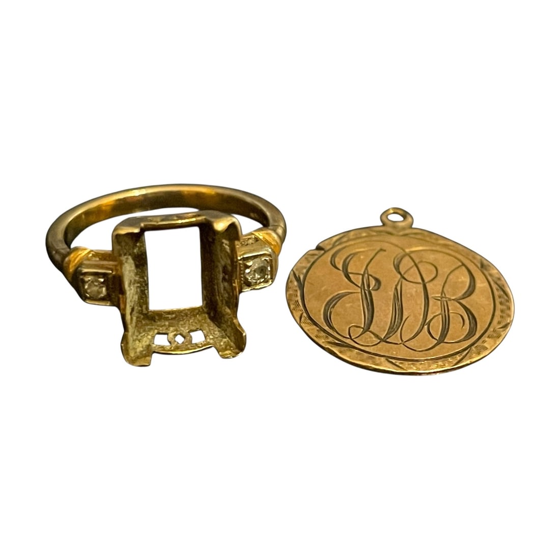 Pair of Yellow Gold Items: A 10kt yellow gold ring and a 10kt gold pendant. Ring size: 3 3.56g H 1 W 1 D 1 inch