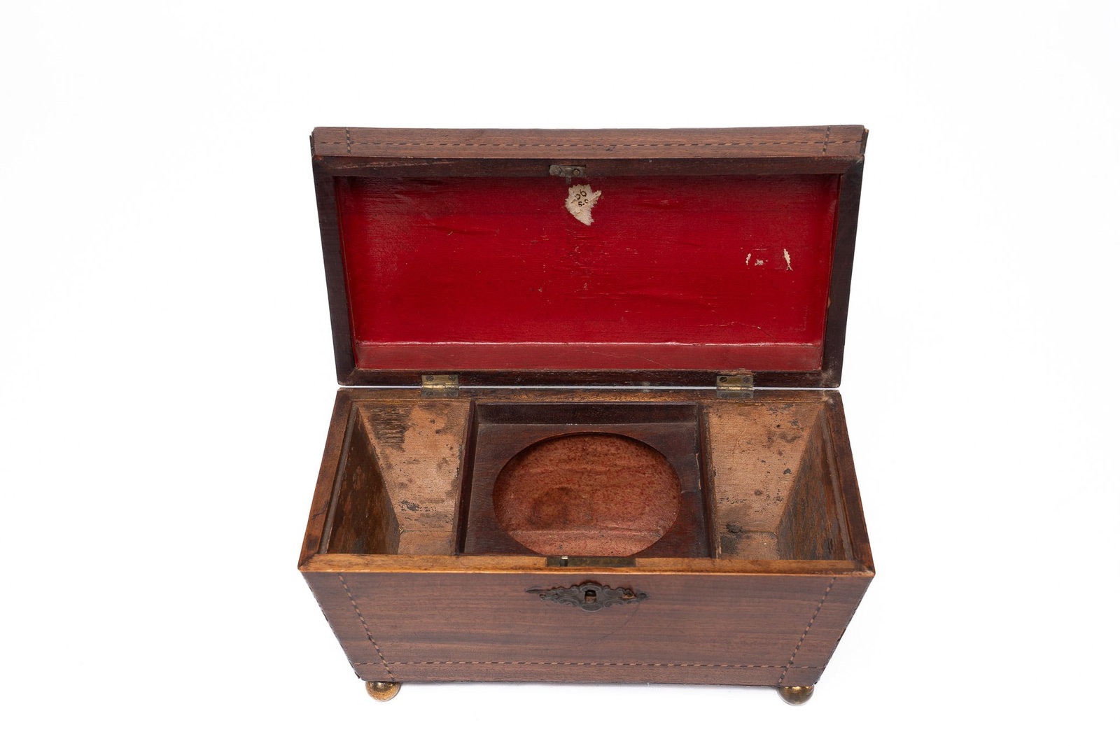 19th Century Wooden Tea Caddy: A lovely 19th Century English tea caddy in a sarcophagus shape. The top offering a bronze plaque with loop. Inlay design outlining the lid and the base. Seated on 4 ball feet. Inside offer