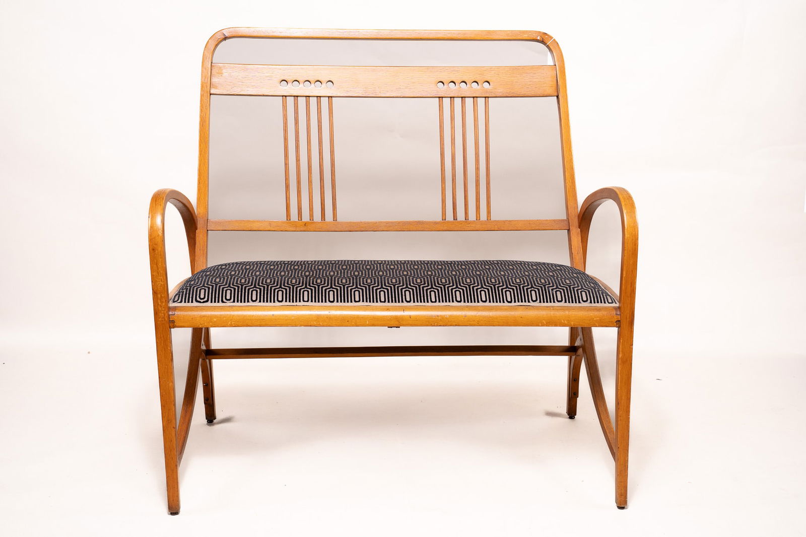 Josef Hoffman for Thonet Vienna Secessionist Bentwood Sofa: An elegant and rare model 511 sofa by Joseph Hoffman. Originally published in 1903 by Thonet. Crafted from natural beech wood. Signed with the Thonet stamp and a label with the same name. Black