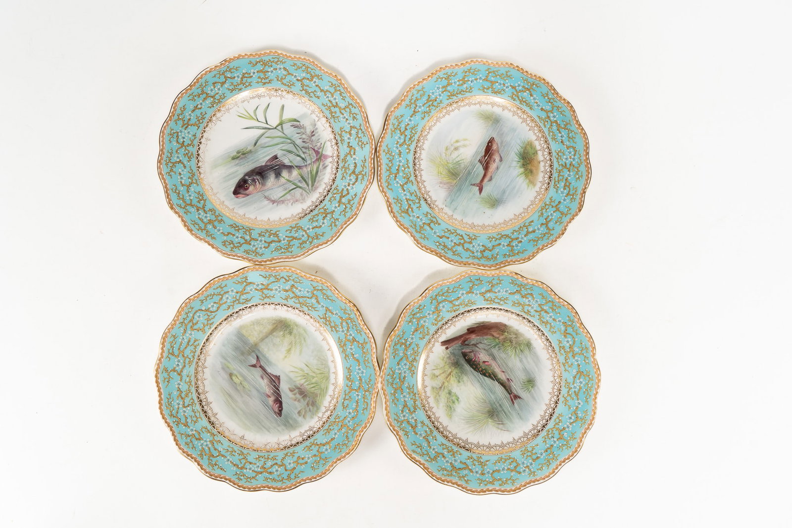 Lot of 4 Antique Brown, Westhead, Moore and Co Porcelain Fish Plates: A beautiful set of antique porcelain plates by Brown, Westhead, Moore and Co fish plates. Gilt trim, blue borders with cherry blossom enameled flowers and the center with fish swimming. Signed on the 
