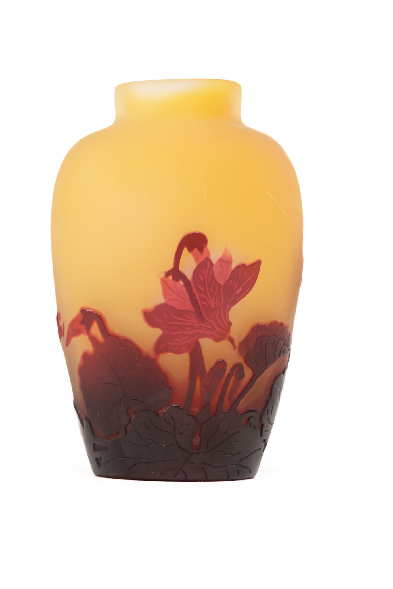 Galle Floral Cameo Art Glass Vase: In reds, ambers, and burgundy. Floral motif on both sides. Signed Galle in cameo. Dimensions: H 5 x W 3 x D 3 inches Condition: Slight mark toward top. No signs of chips, cracks, or repairs.