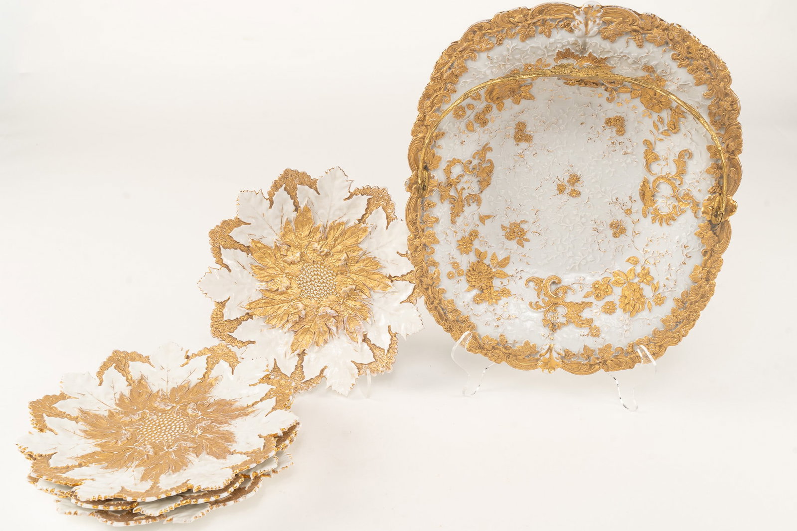 Set of 5 Meissen Porcelain Gilt Grape Leaf Plates and Basket: 4 Dessert Plates by Meissen with Gilt Basket with bronze handle. All marked with blue crossed swords. Plates measure H 8 W 8 D .5 inch each Basket: H 11 W 9.5 D 1.5 inches