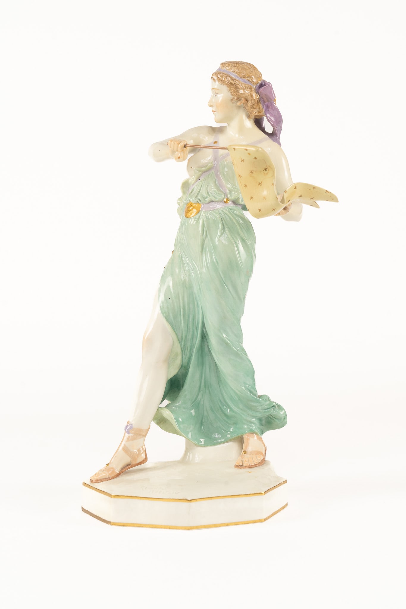 Meissen Porcelain Figure, Woman with Flag: A lovely female figure holding flag wearing a flowing green gown. Signed with the cross swords mark and inscribed Reinhold Boeltzig. Measuring H 15.5 W 6.5 D 6.5 inches Condition: Crack on the left ar