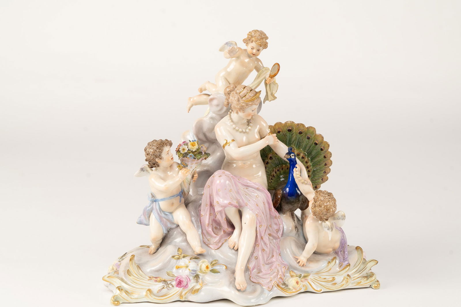 Meissen Porcelain Allegory of the Air: Meissen, Allegory of the Air. Knauffzeit 1850-1924. Designed by Paul Helmig in 1892. Model no O199. Venus on a cloud, accompanied by a peacock, adorned by three cupids. Signed with a crossed sword mar