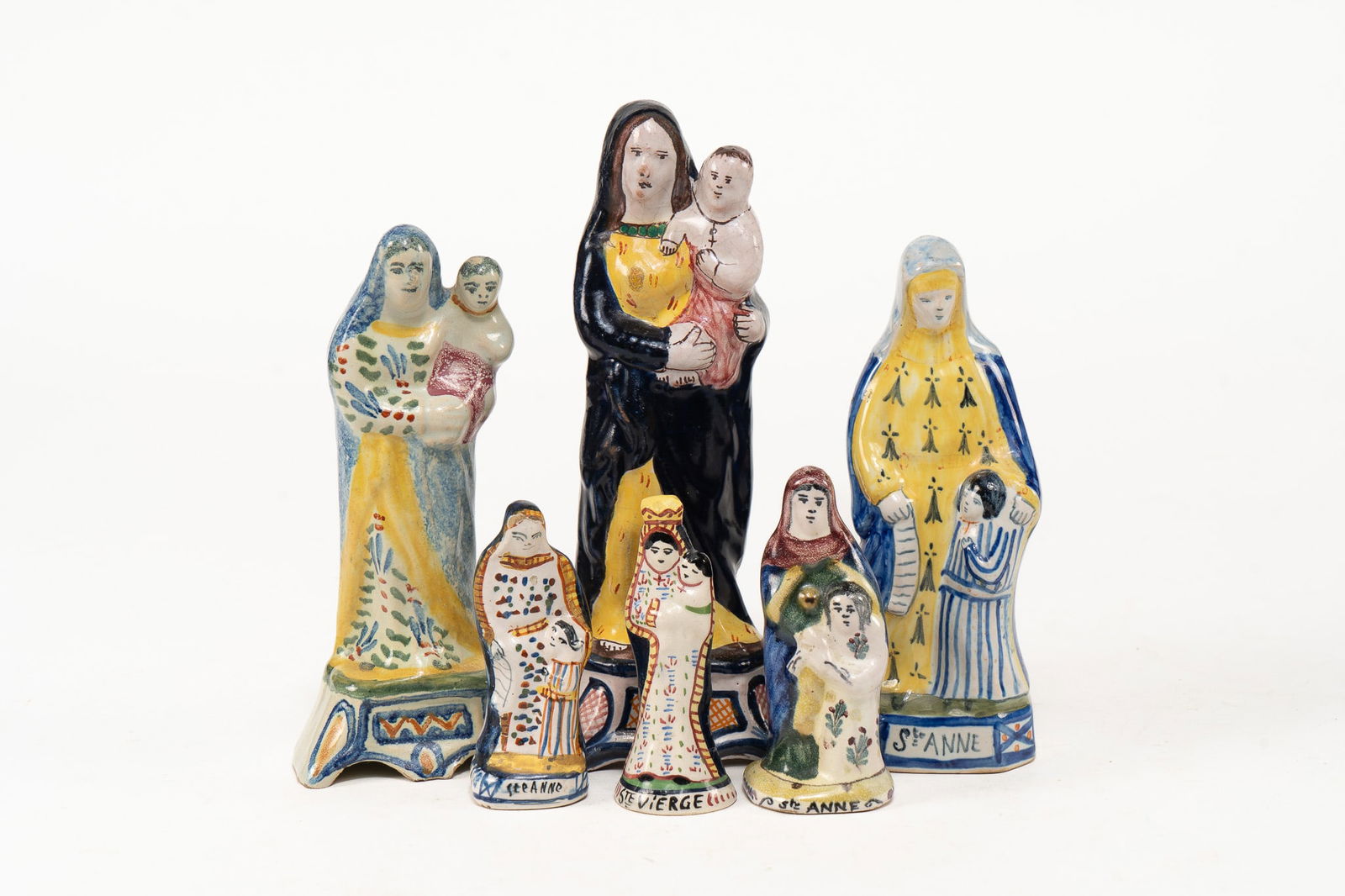 Lot of 6 French Faience Virgin Mary and St Anne Figures: Lot of 6 French Faience Virgin Mary and St Anne Figures. 3 Virgin Mary holding baby Jesus figures of 3 different sizes. Smallest Virgin Mary figure is signed Henriot Quimper inside, others unsigned. 3