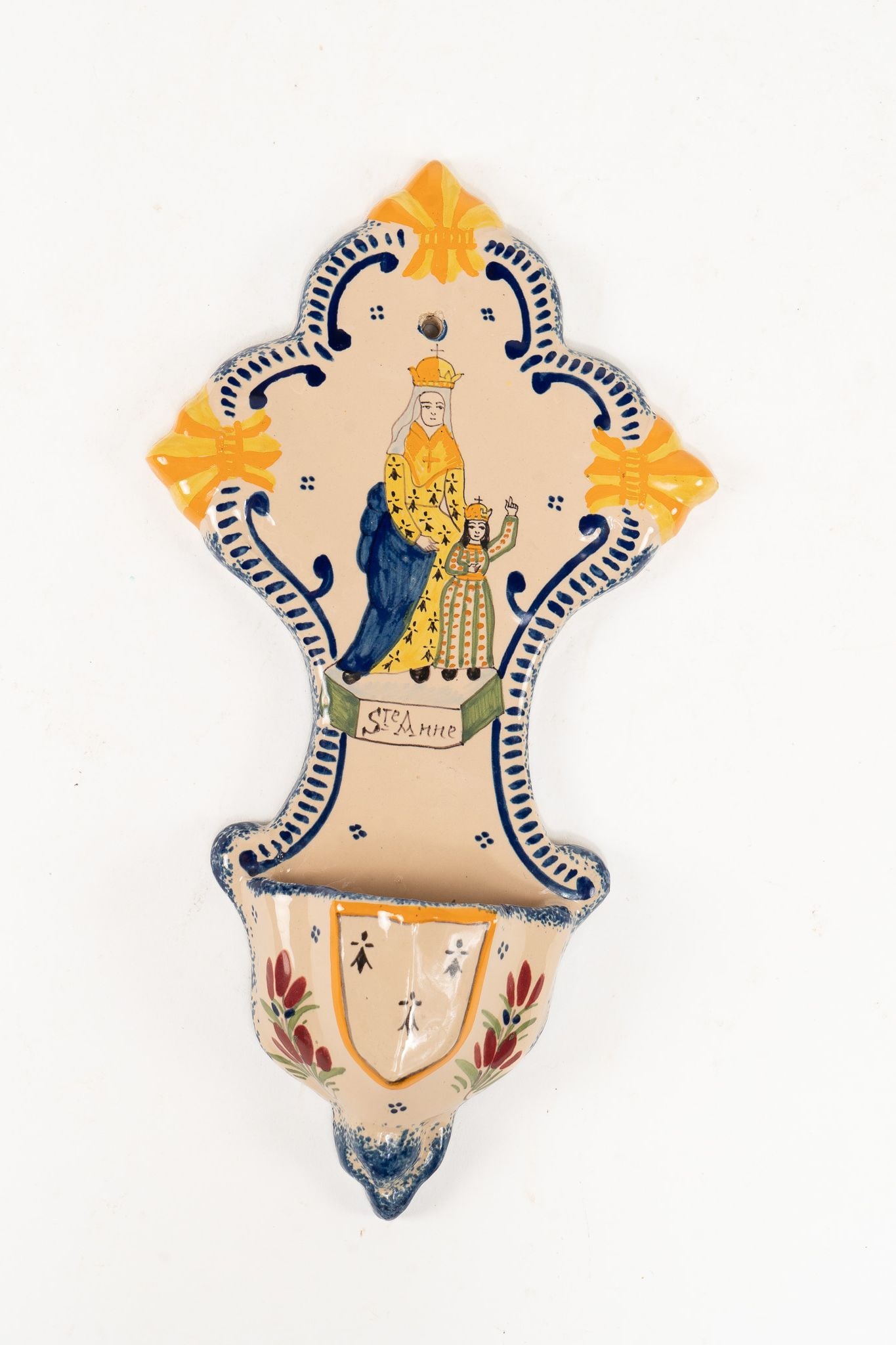 French Faience Henriot Quimper St Anne Holy Water Font: French Faience Henriot Quimper St Anne Holy Water Font. Depicts St. Anne along with blue, yellow, and orange designs as well as red and green flowers. Signed Henriot Quimper on inside back of font.&nb