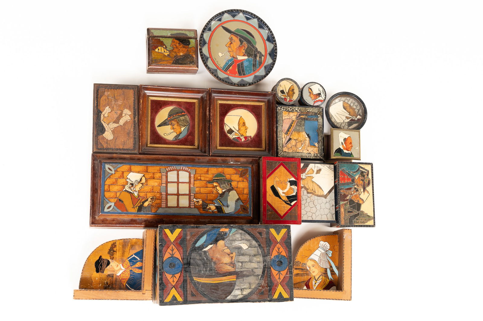 Lot of 17 Assorted Painted Woodenware Items: Lot of 17 Assorted Painted Woodenware Items. Pair of framed Breton man and woman portraits. 1 large lidded box depicting Breton man with pipe. Pair of bookends depicting man and woman in front of tree