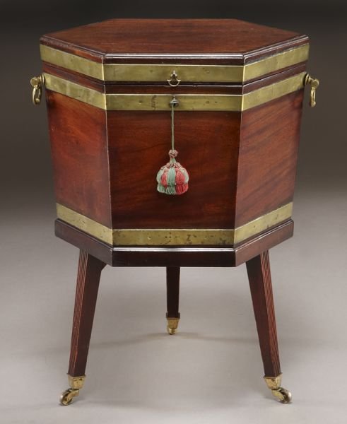 Georgian mahogany brass bound cellarette: Georgian mahogany brass bound cellarette of hexagon shape with original brass handles, square tapered and reeded legs with brass castors. Remnants of original lining to interior. 28.5"H x 20.5"W, Circ