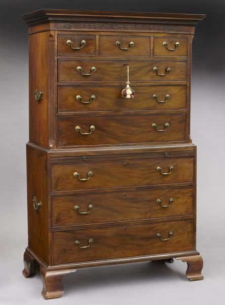 Georgian mahogany chest on chest: Georgian mahogany chest on chest with blind fretwork carving under the cornice, three short over three long graduated drawers in the upper section flanked by canted and fluted corners, on a lower sect