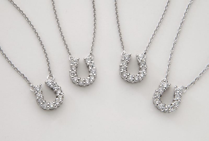 (4) Roberto Coin 18K gold and diamond horseshoe: (4) Roberto Coin 18K gold and diamond horseshoe necklaces, each necklace mounted with ten round brilliant cut diamonds, .11 cts. approximate total each, on an 18K gold chain, also mounted with Robert